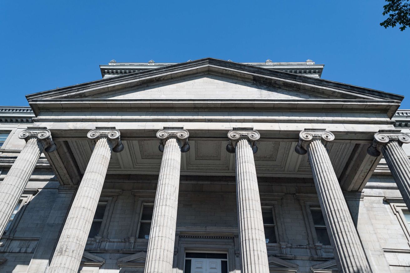 Old Montreal: Vintage building facade with Ionic Greek...