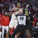 Jan 20, 2024; Houston, Texas, USA; Houston Rockets forward Jabari Smith Jr. (10) and Utah Jazz guard Kris Dunn (11) exchange words during the third quarter at Toyota Center. Mandatory Credit: Troy Taormina-USA TODAY Sports