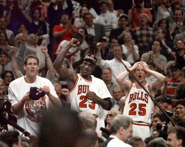 Chicago Bulls players Judd Buechler, left, Michael Jordan, middle, and Steve Kerr celebrate after winning the NBA championship after defeating the Utah Jazz in the 1997 NBA Finals at the United Center. 