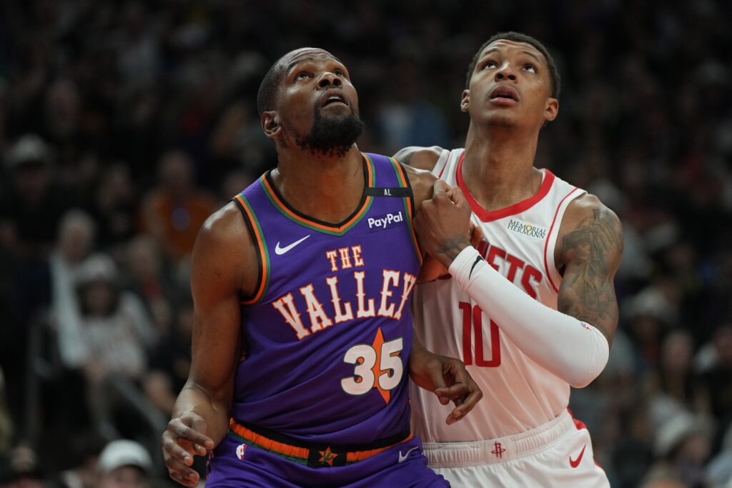 Mar 30, 2025; Phoenix, Arizona, USA; Phoenix Suns forward Kevin Durant (35) and Houston Rockets forward Jabari Smith Jr. (10) fight for position in the first half at Footprint Center. Mandatory Credit: Rick Scuteri-Imagn Images