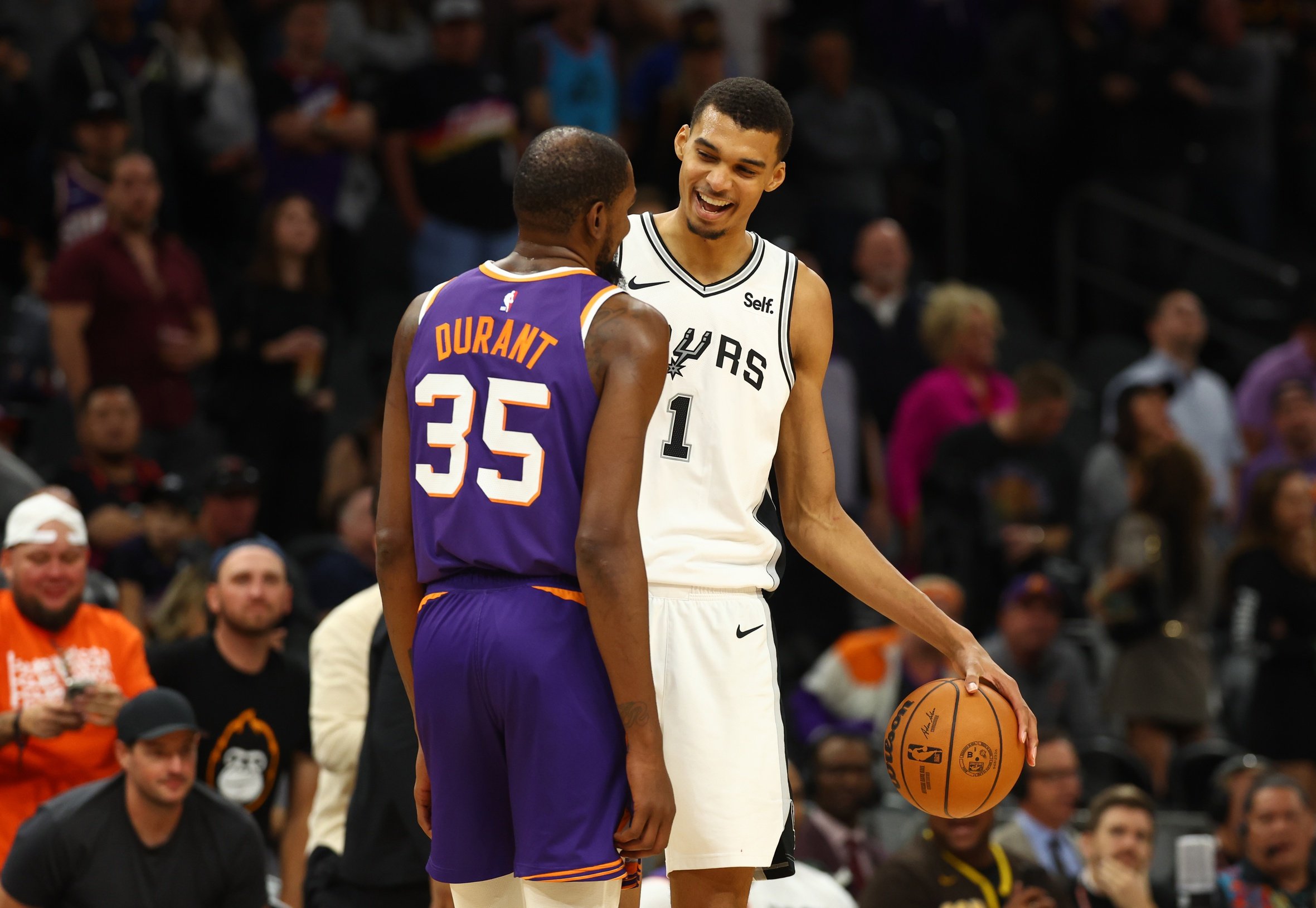San Antonio Spurs center Victor Wembanyama (1) talks with Phoenix Suns forward Kevin Durant (35)