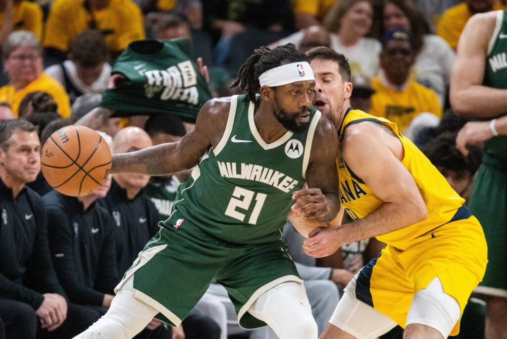 May 2, 2024; Indianapolis, Indiana, USA; Milwaukee Bucks guard Patrick Beverley (21) dribbles the ball while Indiana Pacers guard T.J. McConnell (9) defends during game six of the first round for the 2024 NBA playoffs at Gainbridge Fieldhouse. Mandatory Credit: Trevor Ruszkowski-USA TODAY Sports