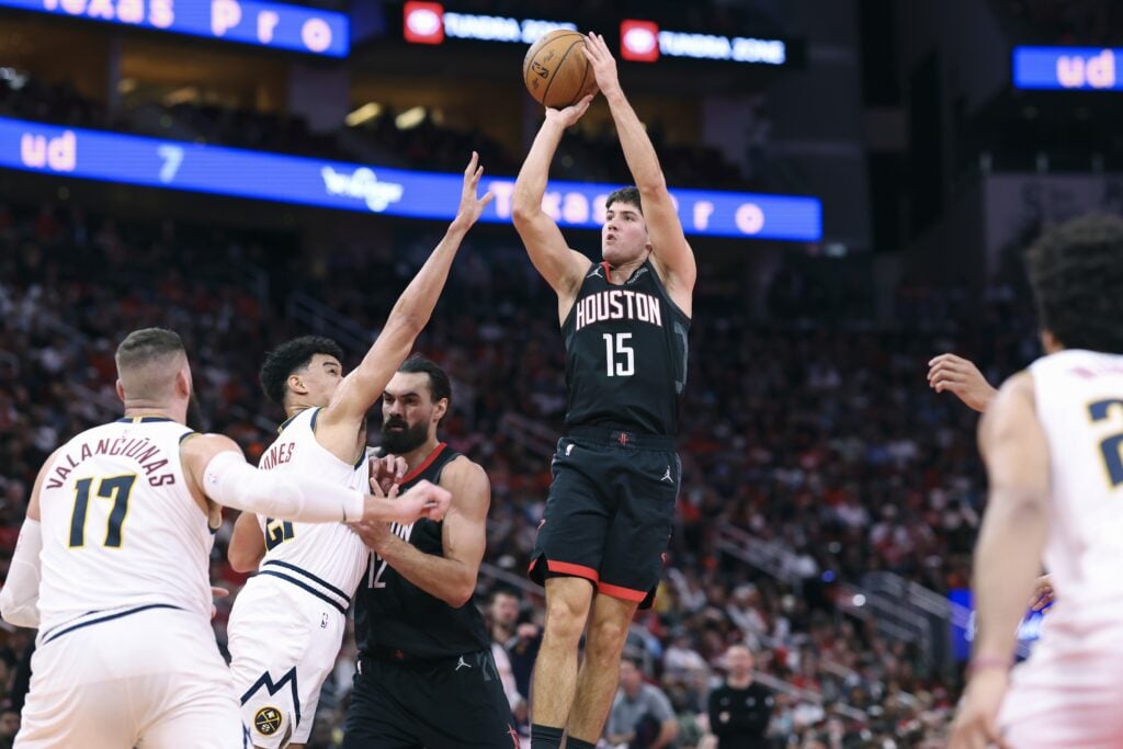 Nov 21, 2025; Houston, Texas, USA; Houston Rockets guard Reed Sheppard (15) shoots the ball as Denver Nuggets forward Spencer Jones (21) defends during the second quarter at Toyota Center. Mandatory Credit: Troy Taormina-Imagn Images